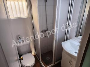 a bathroom with a shower and a toilet and a sink at Casa Sierra Nevada in Antofagasta