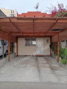 a wooden pergola on a house at Casa Sierra Nevada in Antofagasta