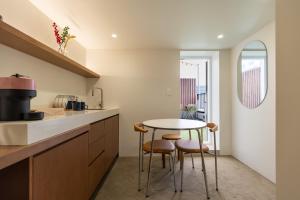 a kitchen with a table and two stools at 루아호텔 in Seoul