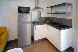 a small kitchen with a refrigerator and a sink at Casa di Sole in Sotta