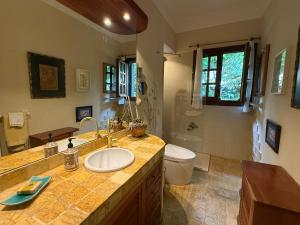 a bathroom with a sink and a toilet at Charming villa with a private pool in Las Rozas de Madrid +16 photos