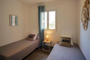 a small bedroom with two beds and a window at Casa di Sole in Sotta +17 photos