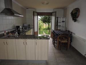 a kitchen with a sink and a table in a room at Casa Rural Nemesio in Iturmendi