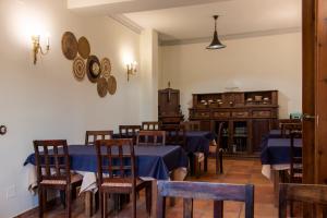 a dining room with blue tables and wooden chairs at La Posada de Maruchi in Pozáldez