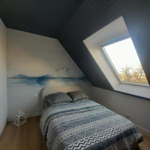 a bedroom with a bed and a window at Gites des menhirs in Camaret-sur-Mer +25 photos