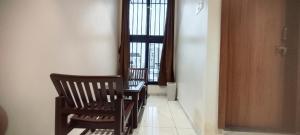 two chairs and a table in a room with a window at Rajwadi Hotel Inn in Valsād