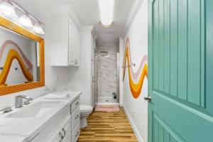 a bathroom with a sink and a toilet and a shower at Once Upon A Tide in Bolivar Peninsula +63 photos