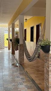 a room with a hammock in a house at Pousada Linhares in Canoa Quebrada +53 photos