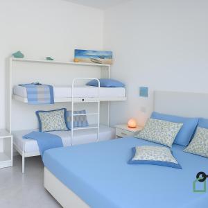 a room with two beds and a bunk bed at Hotiday Room Collection - Torre Lapillo in Torre Lapillo