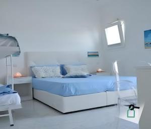 a hospital room with a bed with blue sheets at Hotiday Room Collection - Torre Lapillo in Torre Lapillo