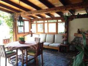 a living room with a table and a couch at Charming villa with a private pool in Las Rozas de Madrid