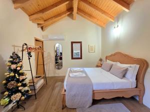 a bedroom with a bed and a christmas tree at Casas da Assureira in Castro Laboreiro