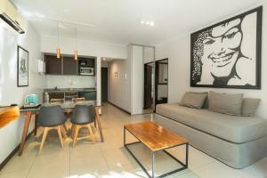 a living room with a couch and a table at Feel Buenos Aires Apartments in Buenos Aires