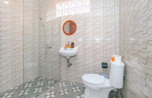 a bathroom with a toilet and a sink at Putra House Ubud in Ubud +16 photos