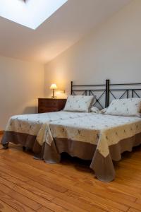 a bedroom with a large bed in a room at La Posada de Maruchi in Pozáldez