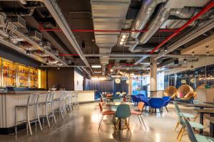 a restaurant with chairs and tables and a bar at Pestana Brussels Schuman in Brussels