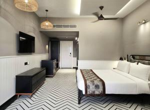 a hotel room with a bed and a television at Hotel Sonar Bangla Susunia in Kālipahāri