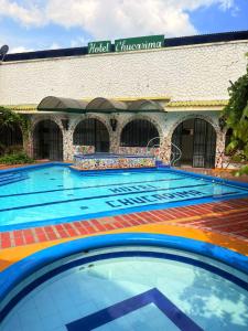 a large swimming pool in front of a building at Hotel Chucarima in Cúcuta