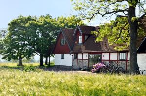 a red and white house with bikes parked in front of it at Torsborgs Gård in Simrishamn