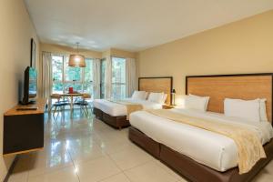 a hotel room with two beds and a television at Feel Buenos Aires Apartments in Buenos Aires
