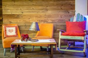 a room with two chairs and a table with a lamp at Hotel Beau Sejour Pré-Saint-Didier in Pré-Saint-Didier