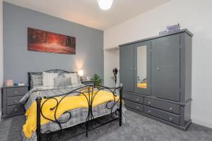 a bedroom with a bed and a dresser at Family-Friendly 2-Bed Home with Games & Fireplace in Colne