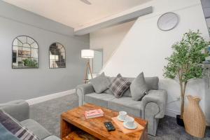 a living room with a couch and a table at Family-Friendly 2-Bed Home with Games & Fireplace in Colne