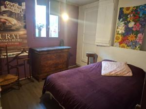 a bedroom with a bed and a dresser and a window at COSY B&B in Murat