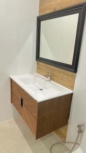 a bathroom with a white sink and a mirror at Chaisona at Khanom Storey in Ban Phaeng +25 photos