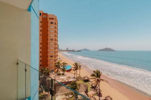 a view of the beach from the balcony of a building at Garner Hotel Mazatlan Beach by IHG in Mazatlán