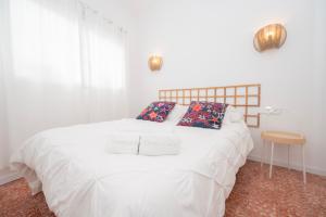 a bedroom with a white bed with two pillows at Carlota Cake in Fuencaliente de la Palma