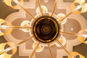 a chandelier hanging from a ceiling at Houston Grand Hotel - River Oaks in Houston
