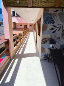 a corridor of a building with a hallway at Pousada Jubarte in Serra +9 photos