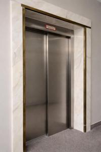 an elevator with a metal door in a building at Sonne Hotel in Herne