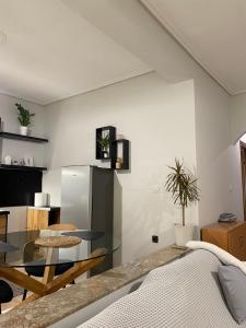a living room with a glass table and a refrigerator at Stylish Suite in Larisa