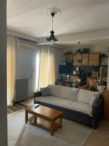 a living room with a couch and a coffee table at Stylish Suite in Larisa