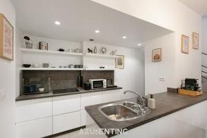 a kitchen with a sink and a microwave at Azurenting - Maison Césario - 3 chambres in Cannes