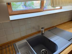 a sink in a kitchen with a window above it at Espacioso e independiente apartamento in Las Rozas de Madrid +13 photos