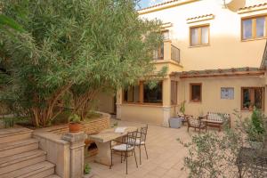 a patio with a table and chairs and trees at Bamboo Garden Oasis with Pool in Pula
