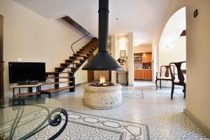 a living room with a fireplace and a staircase at Bamboo Garden Oasis with Pool in Pula