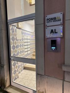 a door to a pomean city house with a sign on it at Pombal City House in Pombal