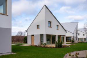 a white house with a gambrel roof at Miło in Lubiatowo
