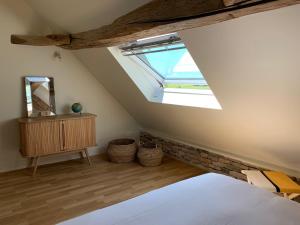 a bedroom with a bed and a skylight at L'Annexe Deveney-Mars in Puligny-Montrachet +16 photos