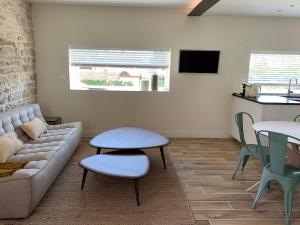 a living room with a couch and a table at L'Annexe Deveney-Mars in Puligny-Montrachet