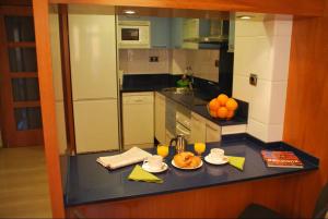 a kitchen with a table with plates of food on it at AmurResidence free parking in Iaşi