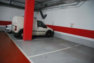 a white van is parked in a garage at AmurResidence free parking in Iaşi