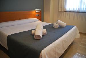 a hotel room with a bed with towels on it at AmurResidence free parking in Iaşi