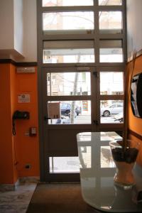 a glass door with a vase on a glass table at AmurResidence free parking in Iaşi