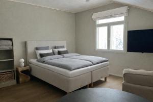 a bedroom with a bed and a window at Lapland Dream Destinations in Rovaniemi