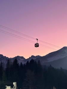a ski lift in the sky at sunset at Chalet Alpenlicht in Oberstdorf